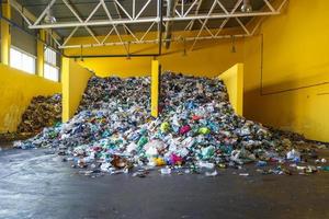 Plastic bales at the waste processing plant. Separate garbage collection. Recycling and storage of waste for further disposal. Business for sorting and processing of waste. photo