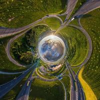 blue sphere of sky with clouds overlooking old town, urban development, historic buildings, crossroads and road junction. Transformation of spherical 360 panorama in abstract aerial view. photo