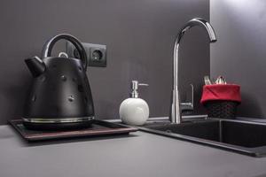 small kitchen interior of flat apartments or hostel in stylish dark color photo