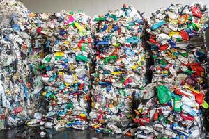 Plastic pressed bales at the modern waste hazardous processing plant. Separate garbage collection. Recycling and storage of waste for further disposal. Business for sorting and processing of waste. photo