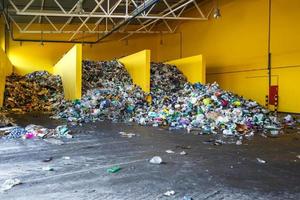 Plastic bales at the waste processing plant. Separate garbage collection. Recycling and storage of waste for further disposal. Business for sorting and processing of waste. photo