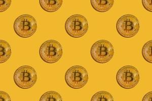 Seamless pattern of virtual money bitcoin on yellow background photo