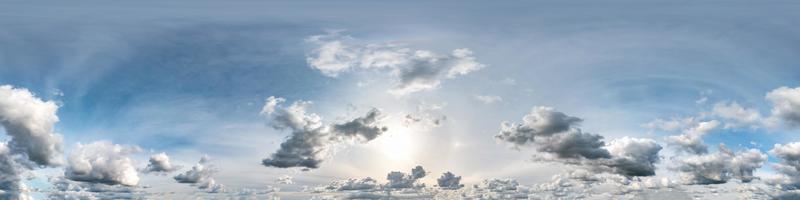 blue sky with beautiful clouds in sunny day with halo. Seamless hdri panorama 360 degrees angle view with zenith for use in 3d graphics or game development as sky dome or edit drone shot photo