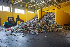 Plastic pressed bales at the modern waste hazardous processing plant. Separate garbage collection. Recycling and storage of waste for further disposal. Business for sorting and processing of waste. photo