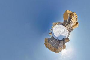 Little planet. Spherical aerial 360 panorama view high-rise building area urban development residential quarter butterfly in winter sunny day on blue background photo