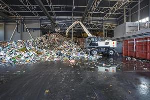 Plastic bales at the waste processing plant. Separate garbage collection. Recycling and storage of waste for further disposal. Business for sorting and processing of waste. photo