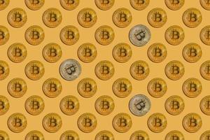 Seamless pattern of virtual money bitcoin with silver splashes on yellow background photo
