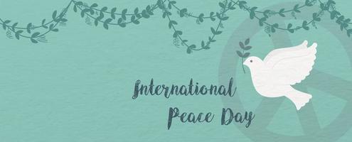 cierre una paloma de la paz con letras del día internacional de la paz y vid en un signo del día de la paz y un fondo de patrón de papel verde. vector
