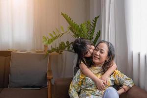 Portrait of a grandmother and granddaughter doing home activities and showing love for one another to create warmth and love within the family. photo