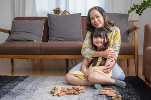 Grandmother and granddaughter play games. Blockwood Puzzle To develop skills for granddaughter and as a holiday activity photo