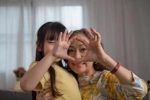 Portrait of a grandmother and granddaughter doing home activities and showing love for one another to create warmth and love within the family. photo