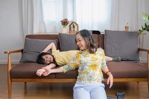 Portrait of a grandmother and granddaughter doing home activities and showing love for one another to create warmth and love within the family. photo