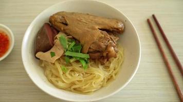 dried noodles with braised duck in white bowl - Asian food style video