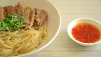 dried noodles with stewed duck in white bowl - Asian food style video