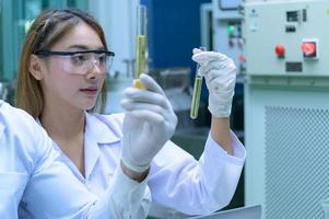 Scientists and assistants are in the oil and cannabis seed extractor room. The extracted cannabis oil is being tested and examined. photo