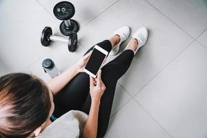 Young sport woman using smart phone in gym, Fitness ,training lifestyle concept photo