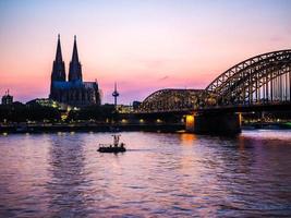 HDR St Peter Cathedral and Hohenzollern Bridge over river Rhine photo