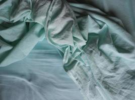 crumpled teal green fabric texture background photo