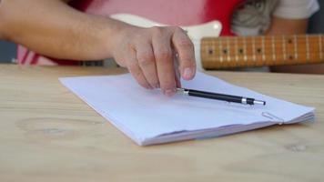 Man composing song using his guitar video