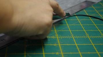 Leather tailor is working with her handmade product video