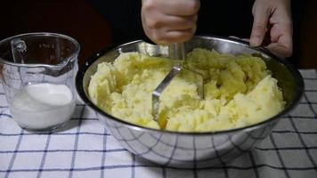 People making homemade mashed potato - food preparation in kitchen concept video