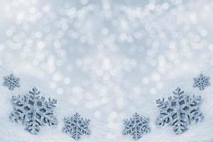 Glass toy snowflake on snow background. photo