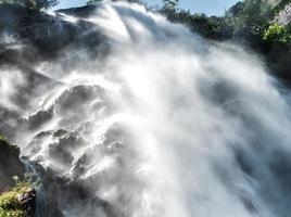 Falling water in a waterfall creates a cloud of water dust. photo