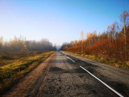 Autumn road. Blue evening sky photo