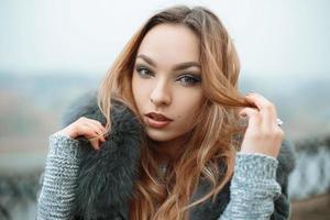 Portrait of a beautiful young girl on a background of fog photo