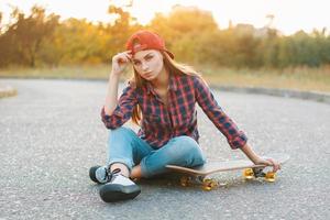Teenager with skateboard portrait outdoors. photo