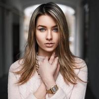 Fashionable beautiful young girl in a pink sweater photo