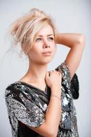 Portrait of a beautiful young blonde girl on a light background in studio photo