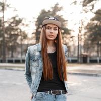Beautiful girl in the fashion denim clothes on a sunset background photo
