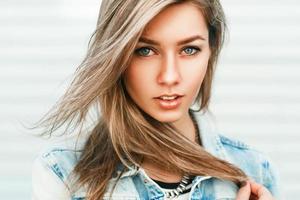 Close up portrait of a pretty woman from Europe in a denim jacket. photo