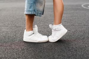 Young hip-hop couple kissing in asphalt. Kiss love standing. photo