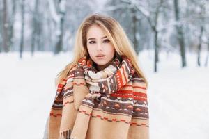 Portrait of a beautiful woman with a warm vintage scarf on a winter day photo