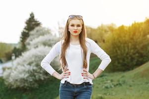 Portrait of a beautiful girl on a background of the spring landscape. Sunset. photo