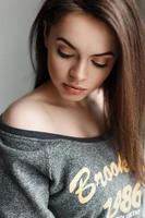 Young beautiful brunette girl looking down. photo