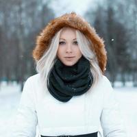 hermosa chica en una chaqueta de invierno en el parque foto
