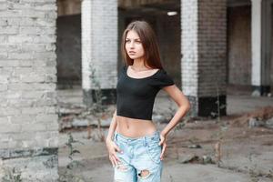 Beauty woman with fashion casual clothes in blue torn jeans on the street photo