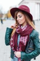 Beautiful fashionable woman in a hat and scarf posing photo