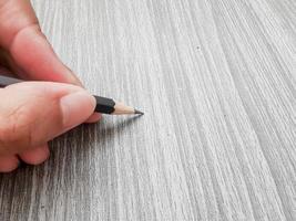 hand holding a pencil writing photo