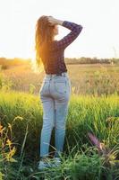 Portrait of a beautiful young woman on meadow photo