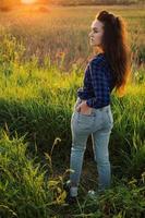 Portrait of a beautiful young woman on meadow photo