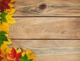 Autumn leaves on wooden table photo