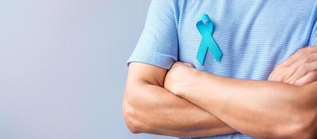 Blue November Prostate Cancer Awareness month, Man in blue shirt with hand holding Blue Ribbon for support people life and illness. Healthcare, International men, Father, Diabetes and World cancer day photo