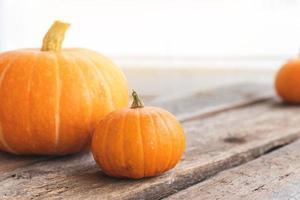 Autumnal Background. Natural autumn fall view pumpkins on wooden background. Inspirational october or september wallpaper. Change of seasons ripe organic food concept, Halloween party Thanksgiving day photo