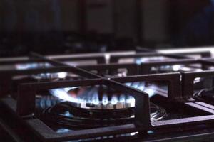 Blurred background. Blue gas flame on the gas stove photo