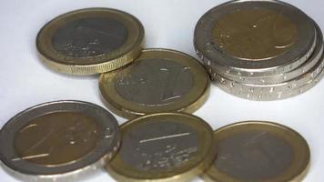 Loopable selective focus view on many euro coins in close up view spinning in circle . video