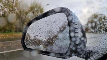 Selective focus view in the side mirror of a car in heavy rain. video